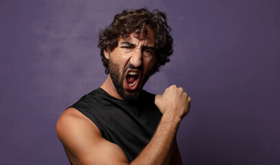 Obraz premium young bearded crazy fitness man sport concept