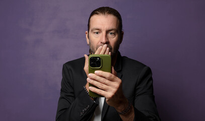 blonde adult man with a smartphone