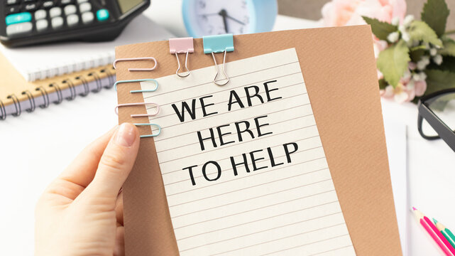WE ARE HERE TO HELP written on a white sheet held by a person. Sponsorship concept