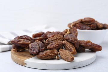 Tasty dried dates on light table, closeup