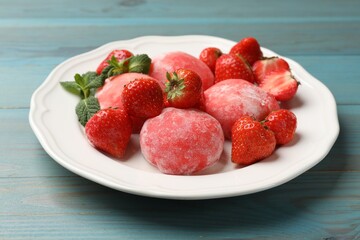 Delicious mochi, strawberries and mint on light blue wooden table, closeup