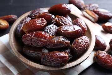 Tasty dried dates on black table, closeup