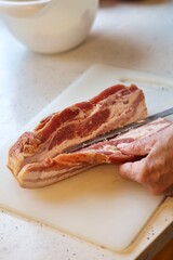 Close-up of bacon during the preparation, cutting and cooking process