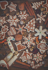 christmas baked gingerbread snowflakes cookies with evergreen twigs on wood, color of the year 2025 mocha mousse