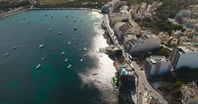 Aerial Drone View of Bugibba Malta Marina with Yachts and Boats on the Waterfront of a Beautiful Tourist City on the Mediterranean Sea. High quality 4k footage