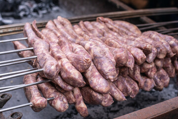 Sausages grilling on the barbecue, a delicious dish made with pork or beef
