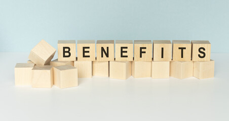 benefits word written on wood block on a light background