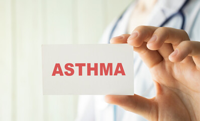 Doctor holding a card with text ASTHMA, medical concept