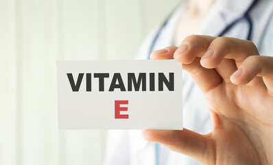 Vitamin E written on a card in doctors hands