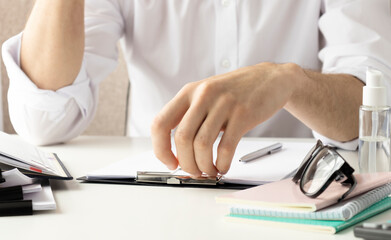 Fototapeta premium Getting ready for consultation. Dark-haired bearded doctor in a white robe looking involved