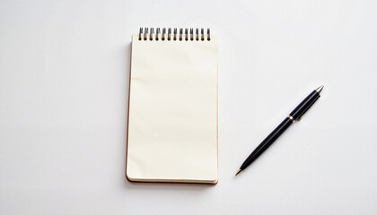 Spiral notepad with black pen on white background