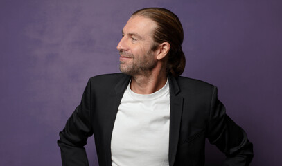 looking happy, cheerful and confident, smiling proudly and looking to side with both hands on hips