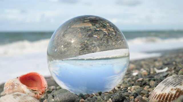 Reflection of sea landscape in crystal ball.