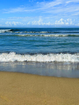 Ocean waves on sandy beach 