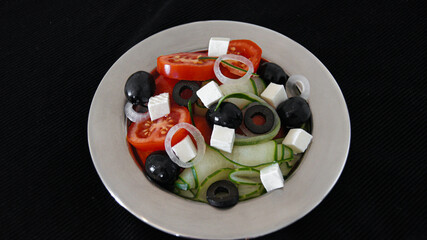 Greek salad with pixel tomatoes, cucumbers, salamoya olives, feta cheese, white onion, olive oil....