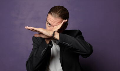 covering face with hand and putting other hand up front to stop camera, refusing photos or pictures