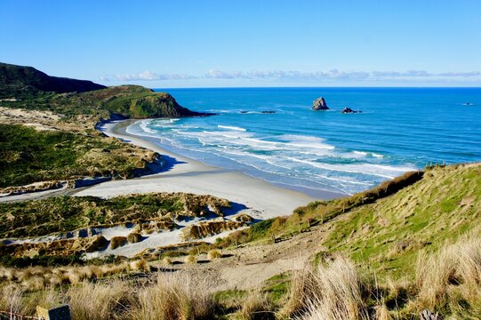 Sandfly Bay, Otago Peninsula. It is a sandy bay with large dunes 15 kilometres east of central Dunedin, New Zealand.