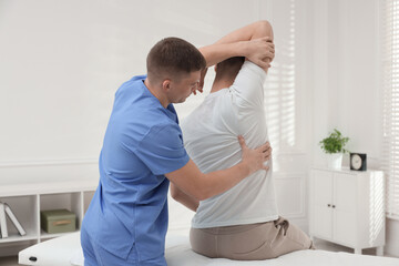Fototapeta premium Osteopath working with patient in clinic. Manual therapy