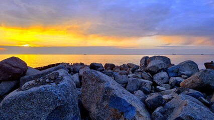 Sunset on the seashore, dark clouds in the sky