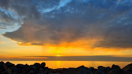 Sunset on the seashore, dark clouds in the sky