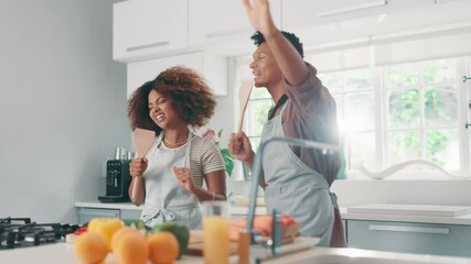 Couple, happy and cooking with singing in kitchen for bonding, meal preparation and fun together. People, karaoke and dancing in home for anniversary date, celebration and commitment in relationship