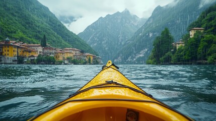 A yellow kayak on a lake with mountains in the background