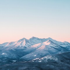 Fototapeta premium Majestic snow-capped mountain peaks at dawn with clear sky