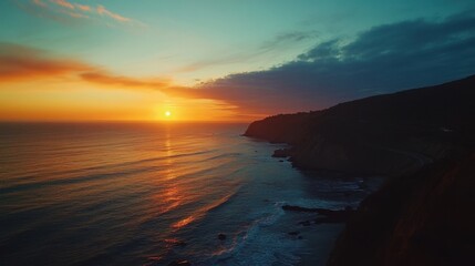 Obraz premium Drone capturing ocean sunset over cliffs