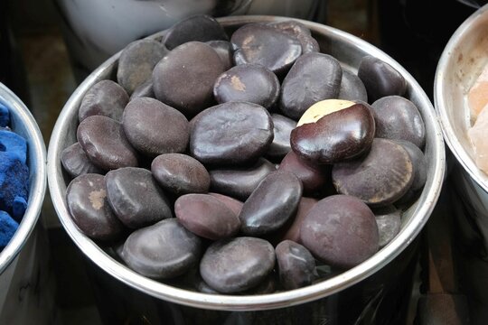 Seeds of Entada Rheedii, African Dream Herb (Entada phaseoloides) seeds in a bowl at bazaar Grand Souq in Deira, Dubai, UAE. 
