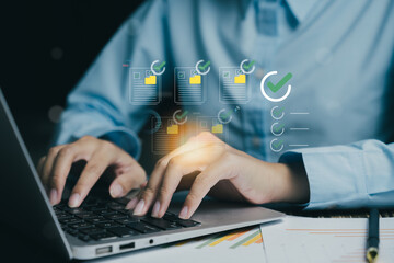 person working on laptop, managing documents and checklists, with focus on productivity and organization. scene conveys sense of efficiency and modern technology
