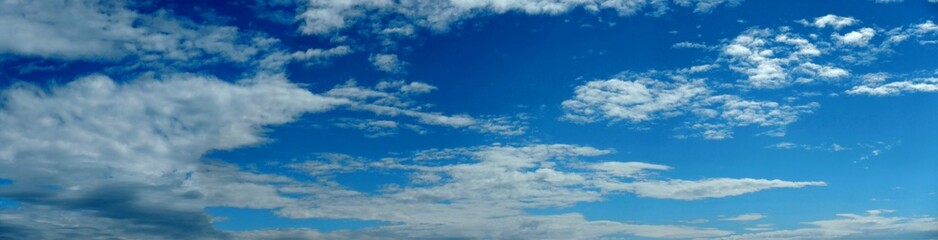 Blue sky with white clouds - natural air space panorama. Topics: weather, meteorology, atmosphere, nature, background