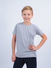 T-shirt design concept. Teen boy in blank gray t-shirt, isolated on white background.