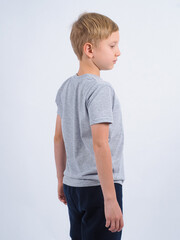 T-shirt design concept. Teen boy in blank gray t-shirt, isolated on white background.