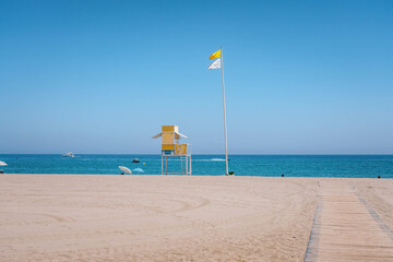 Lifeguard tower standing on sandy beach under blue sky. PUERTO BANUS, MARBELLA