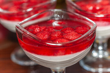 Panna cotta dessert with strawberries and raspberries served in a glass	