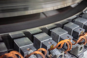 Hydro generator static excitation system. Carbon brushes in brush holders and slip rings of the excitation system of a 80 MW vertical synchronous hydrogenerator, close-up.