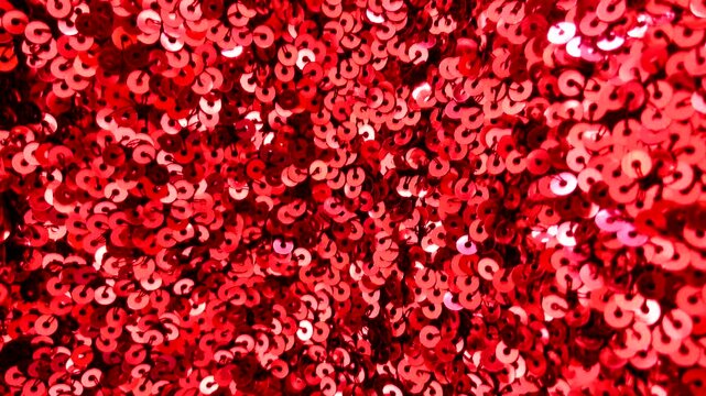 Red sequin fabric with shimmering highlights luxurious textured background for design.Holiday abstract glitter texture with blinking lights,4K video