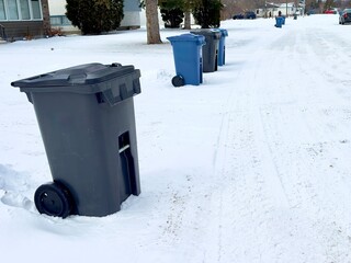 garbage bins for separate waste stand in a line on the street