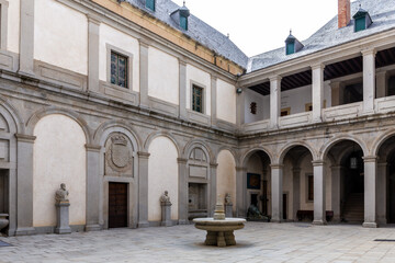 Obraz premium Herrerian style courtyard of the Alcazar of Segovia, Spain, columns and cloisters, fountain in the middle, no people.