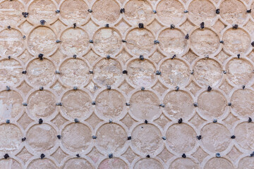 Ornamental stone facade of the Alcazar of Segovia, Spain. Islamic ornaments with circular sgraffito...
