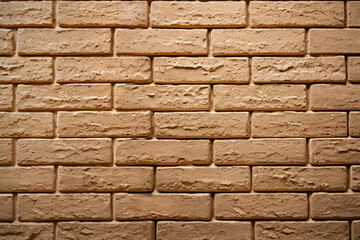 Fototapeta premium Light brown bricks form a textured wall surface. 