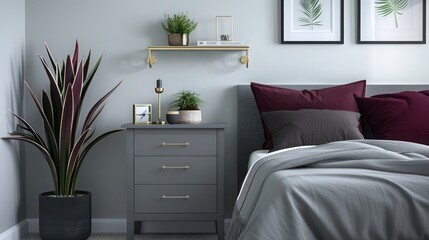 Contemporary bedroom with a grey nightstand, charcoal accents, burgundy linens, brass wall shelf, and minimal plants in a minimalist design.