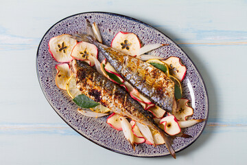Grilled mackerel fish with roasted potatoes and broccoli. View from above, top studio shot