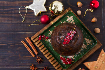 Fruit cake pudding and Christmas decorations. Fruitcake ball, traditional dessert on Christmas. Top view with copy space