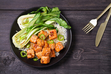 Salmon teriyaki with pak choi and rice. View from above, top studio shot