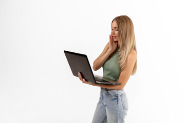Naklejka premium A young woman with long hair engages in a virtual conversation while holding a laptop in a bright, minimalistic setting