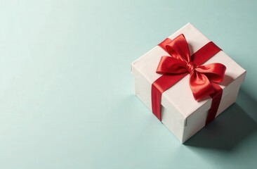 Obraz premium white gift box with red ribbon on pastel background