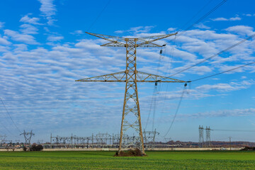 High voltage pylon in the French countryside. 400 kV High voltage electric power grid. Electrical transformer and distribution substation in Mions, Rhone, France