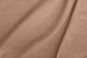 Aesthetic neutral background in trendy color of 2025 year, soft crumpled warm mocha brown linen fabric backdrop with natural shadows