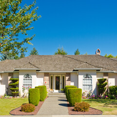 Entrance of grey painted luxury house in summer with stair steps and nice landscape in Vancouver,...